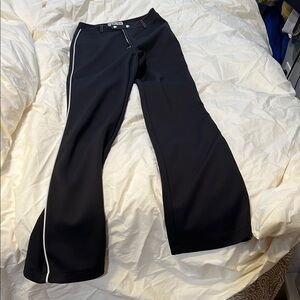 I.AM.GIA High-Waist Black Wide-Leg Pants with White Strip Hem.